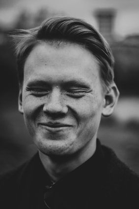 grayscale photo of smiling man