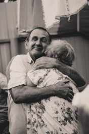 grayscale photography of man and woman embracing