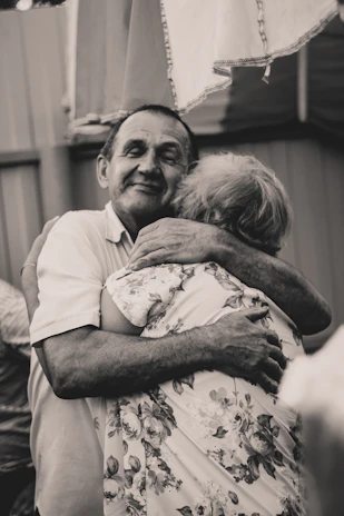 The pastor and his wife warmly greeting church members after service.