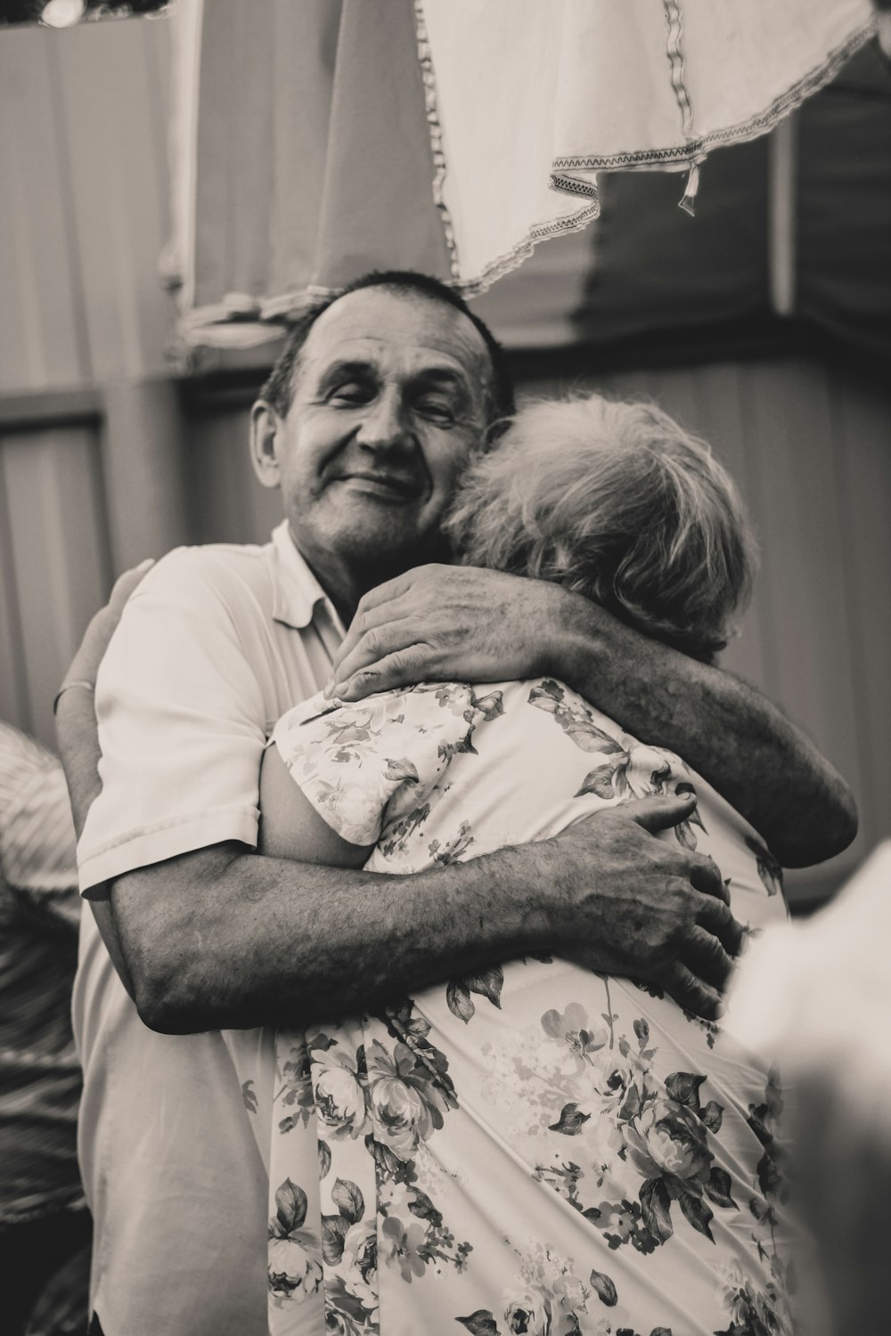 grayscale photography of man and woman embracing