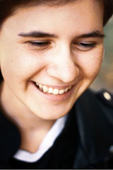 Side profile of a relaxed person smiling gently, showcasing the comfortable fit of the aligner.