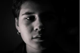 A bright, minimalist portrait session with natural light highlighting the subject's expression.