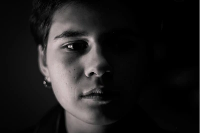 A bright, minimalist portrait session with natural light highlighting the subject's expression.