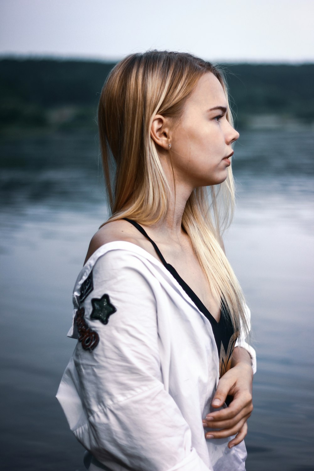 woman standing beside sea