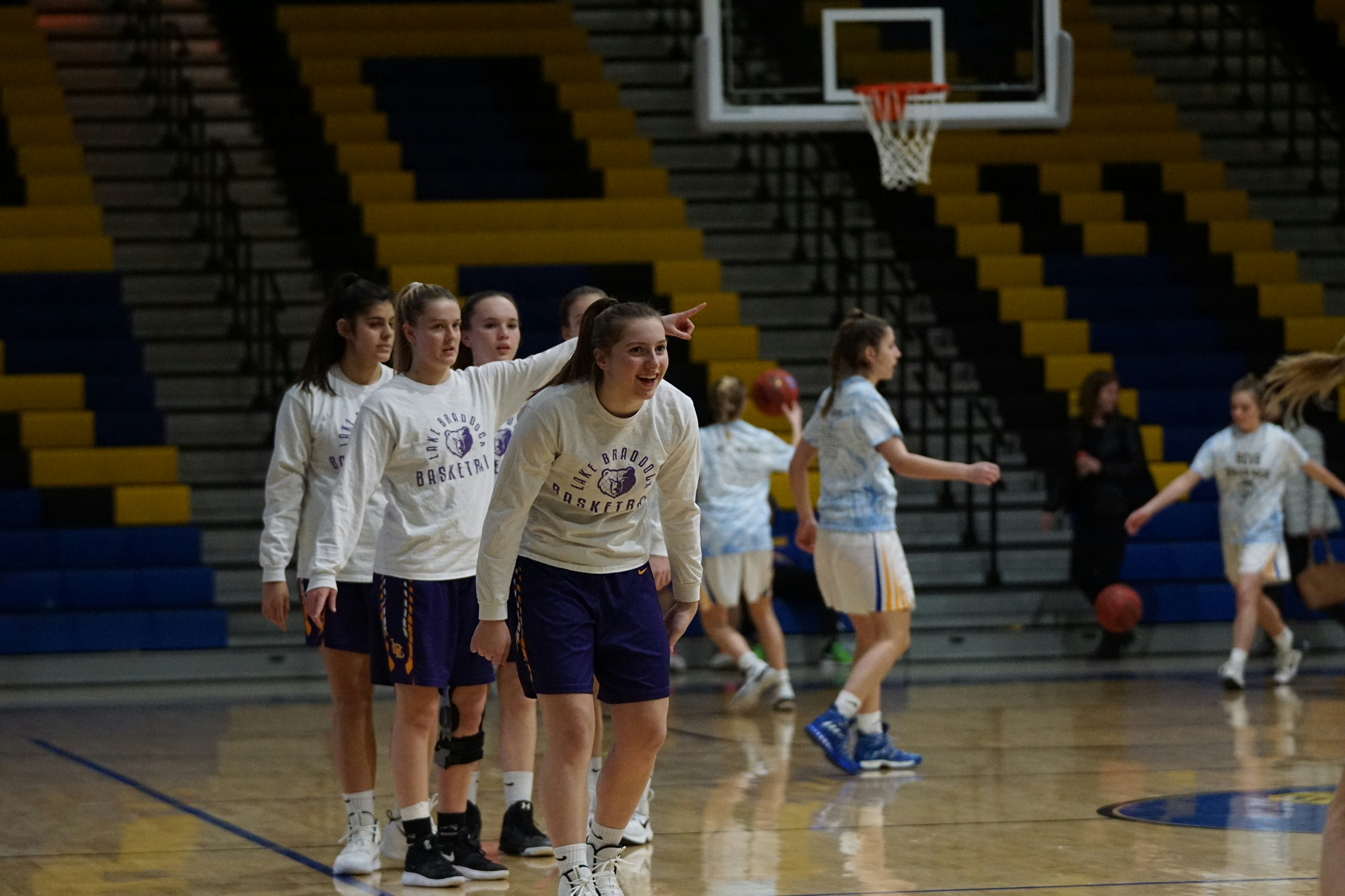 group of girls playing basketball inside court
