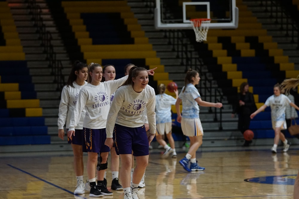 group of girls playing basketball inside court