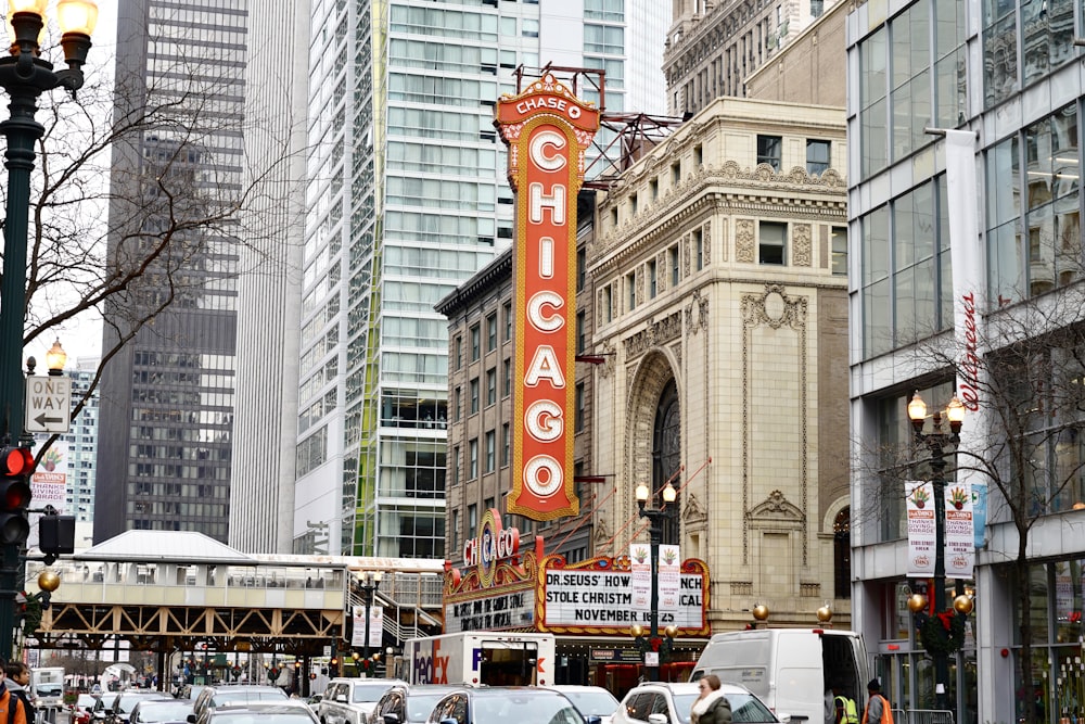 cars on road surrounded by highrise buildings during daytime