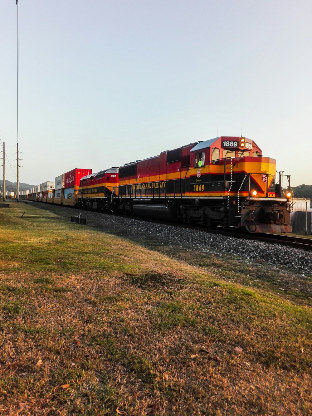 orange train under white sky during daytime