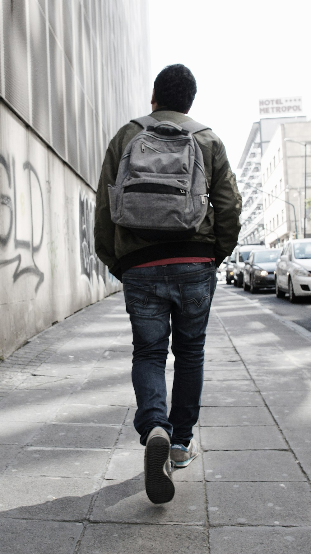 man walking on sidewalk