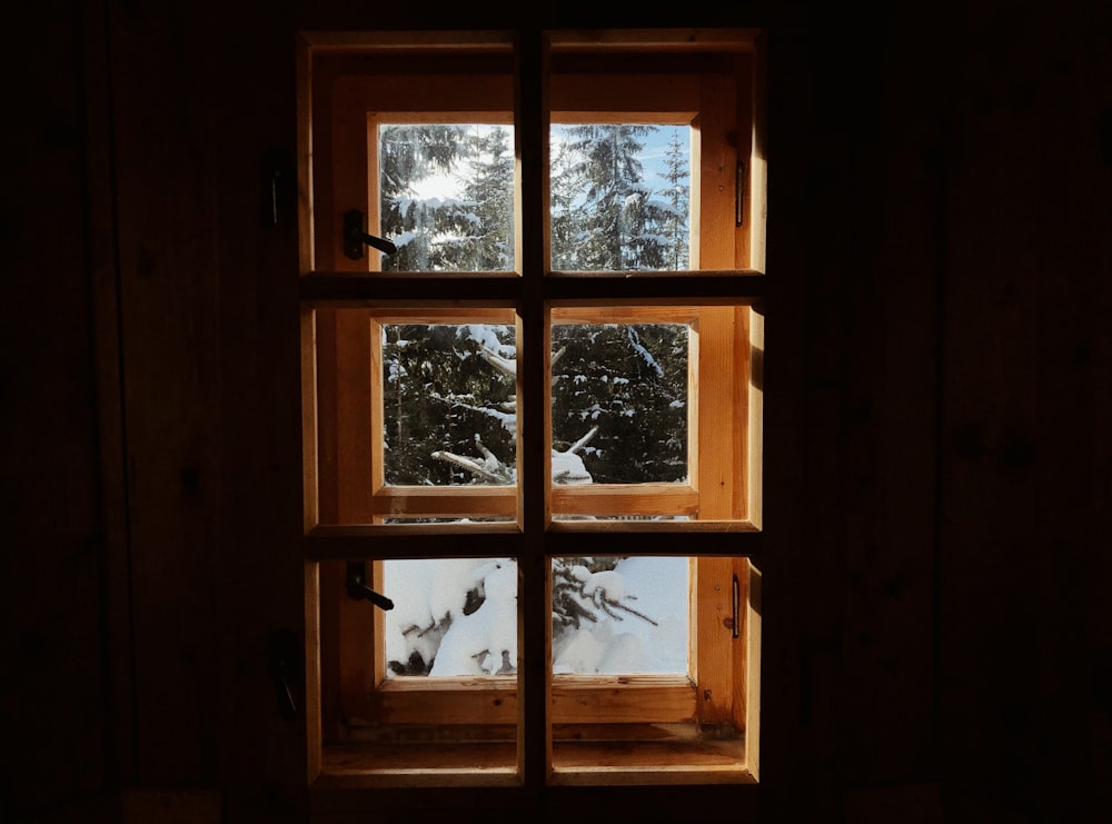 closed brown wooden framed clear glass window