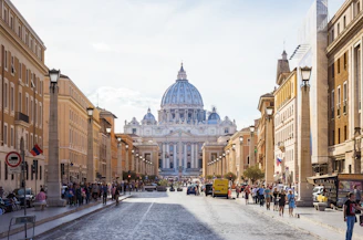 people walking beside white and brown dome building during daytime