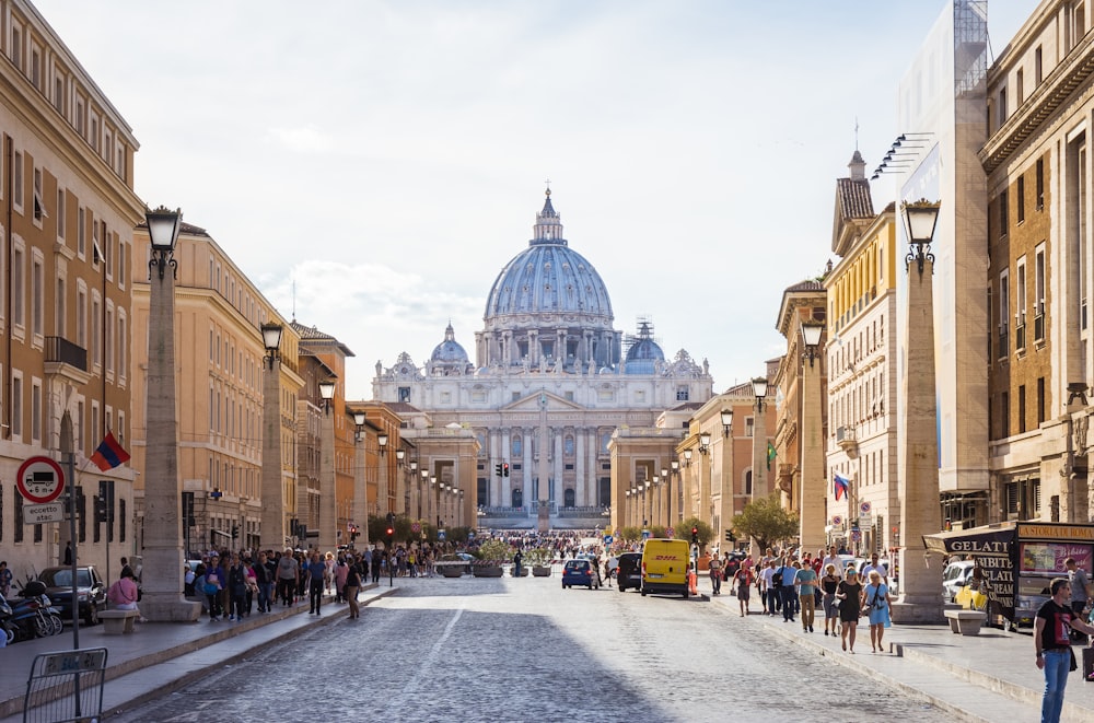 people walking beside white and brown dome building during daytime