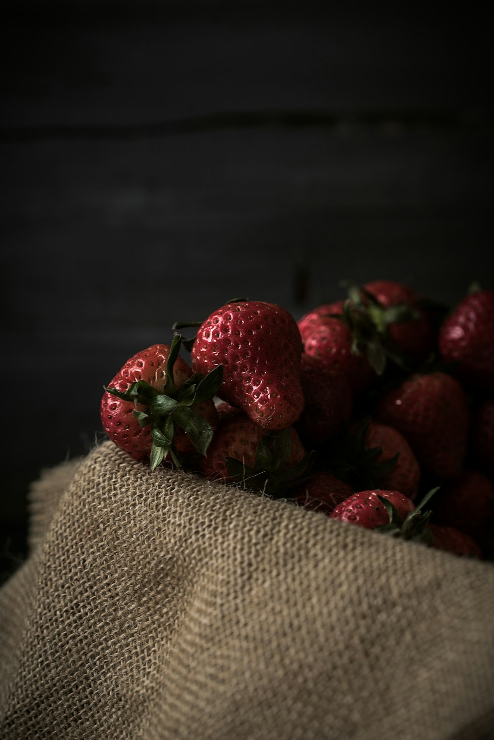 strawberries on brown textile