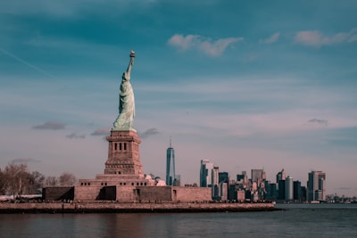 A vibrant cityscape of New York with the Statue of Liberty in the foreground.