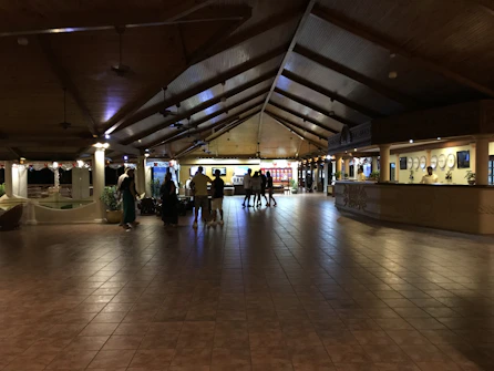 A welcoming hotel lobby desk with warm lighting and friendly staff ready to assist guests.