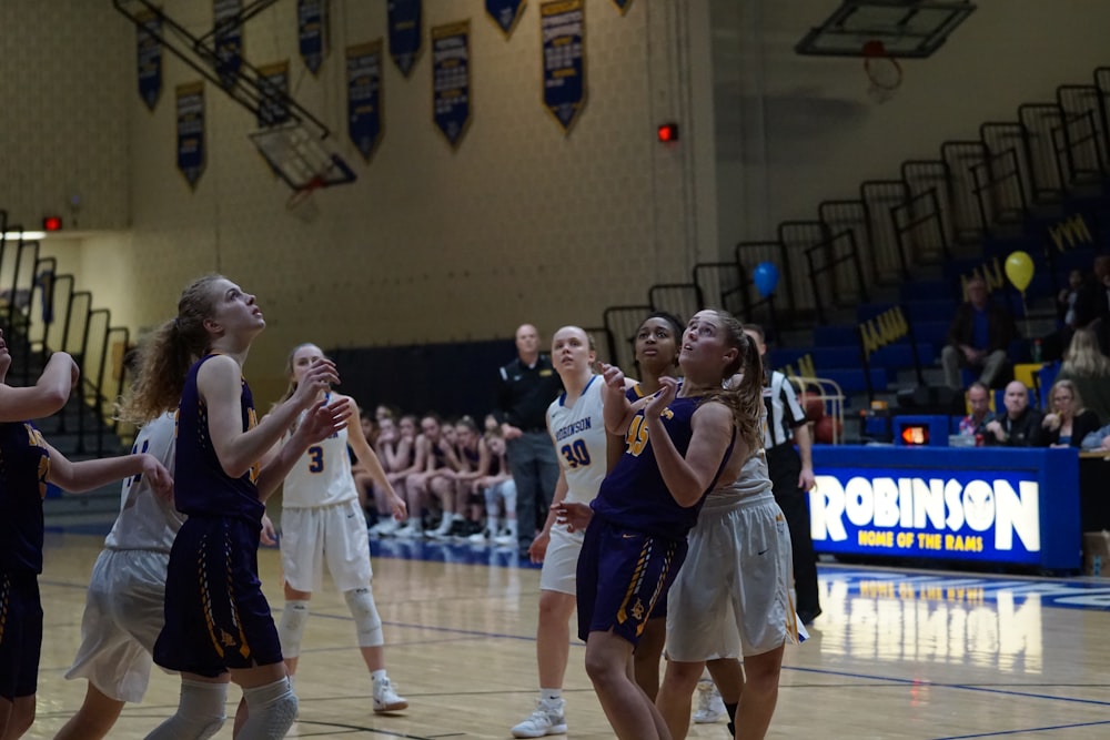 female basketball players playing on robinson court