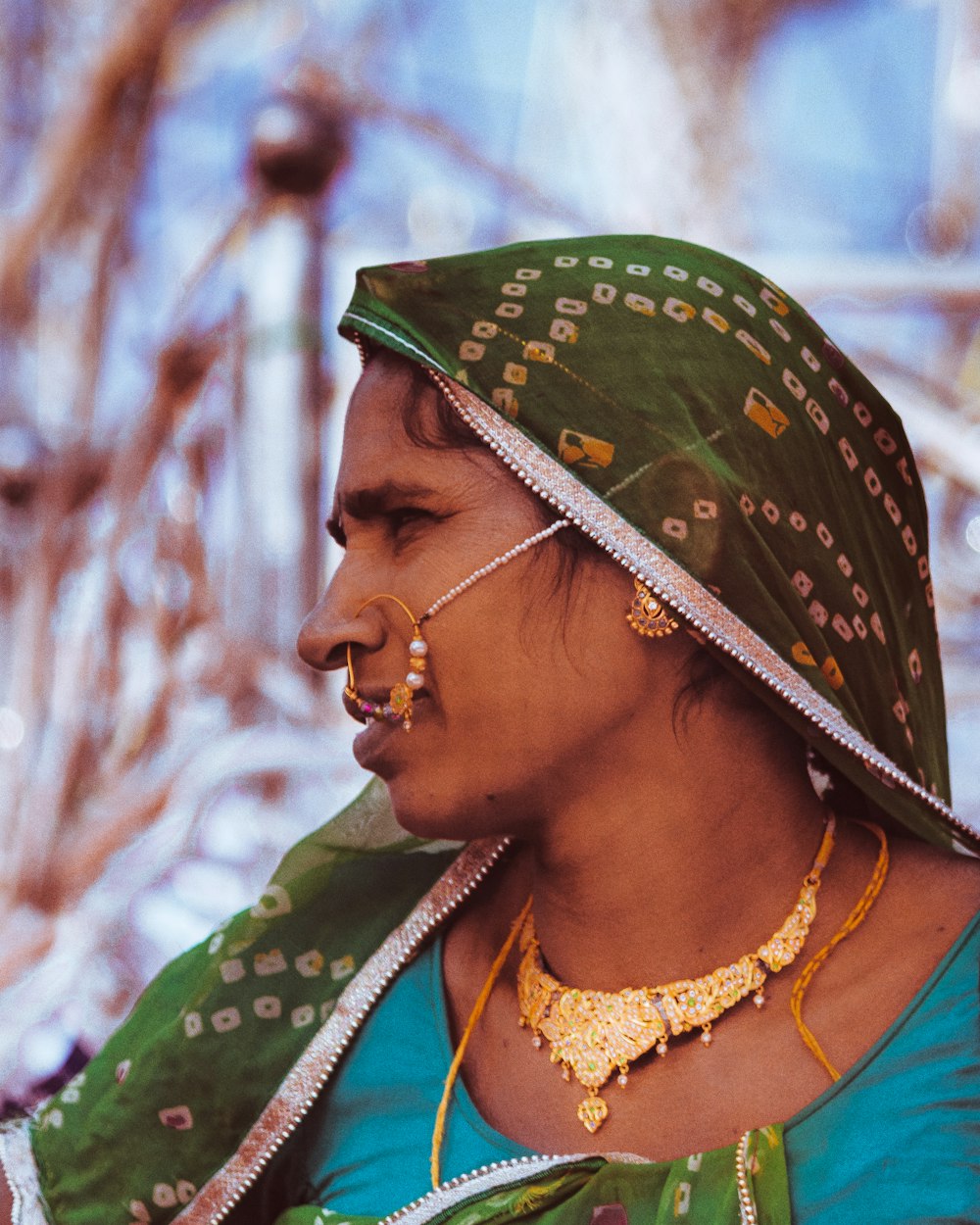 woman looking at the right side while wearing green hijab