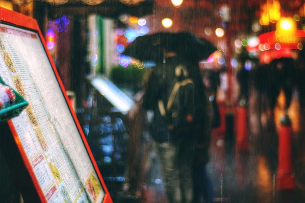 selective photo of written board on street during nighttime