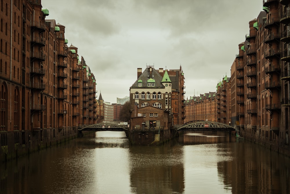 body of water between two brown buildings