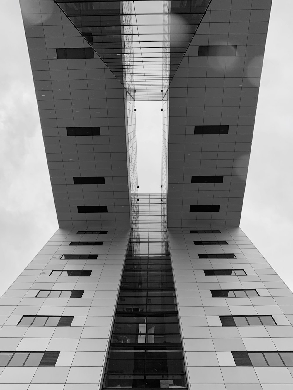 low-angle photography of building with bridge during daytime