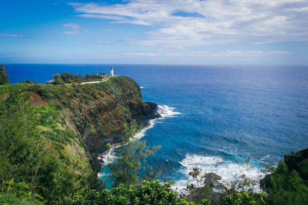 white lighthouse tower over the cliff