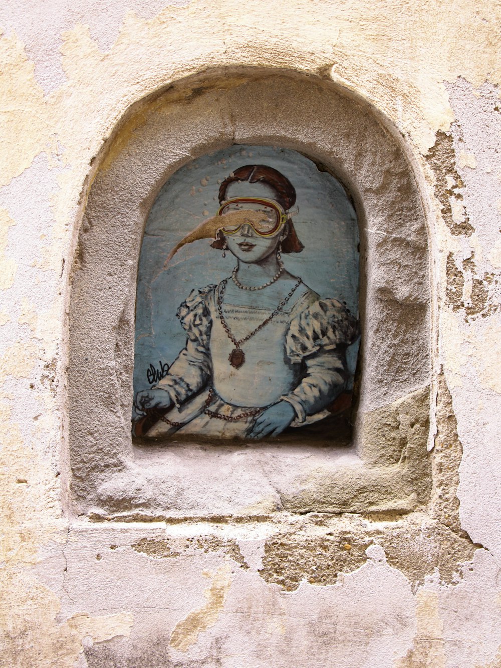 woman wearing goggles wearing necklace painting on arched wall