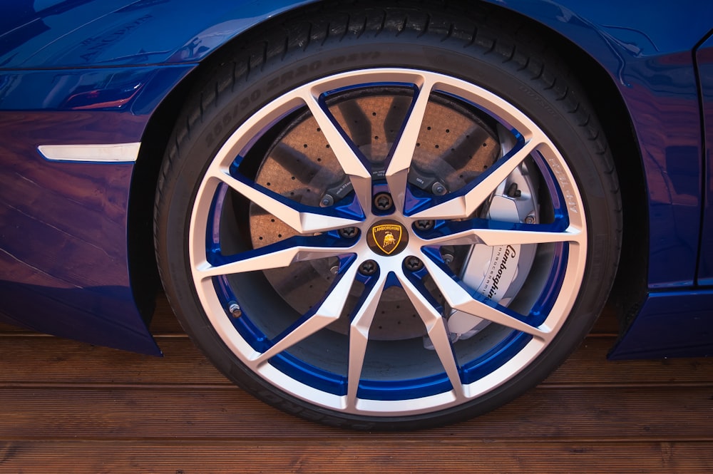 chrome and blue multi-spoke vehicle wheel and black tire