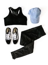 women's black sports bra, blue cap, pair of Vans sneakers, and black denim jeans