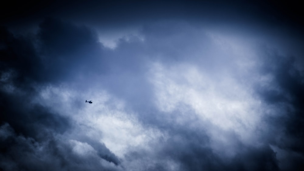 helicopter flying at high altitude during daytime