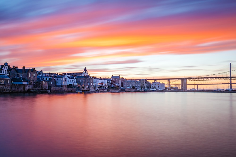 city beside bridge during golden hour