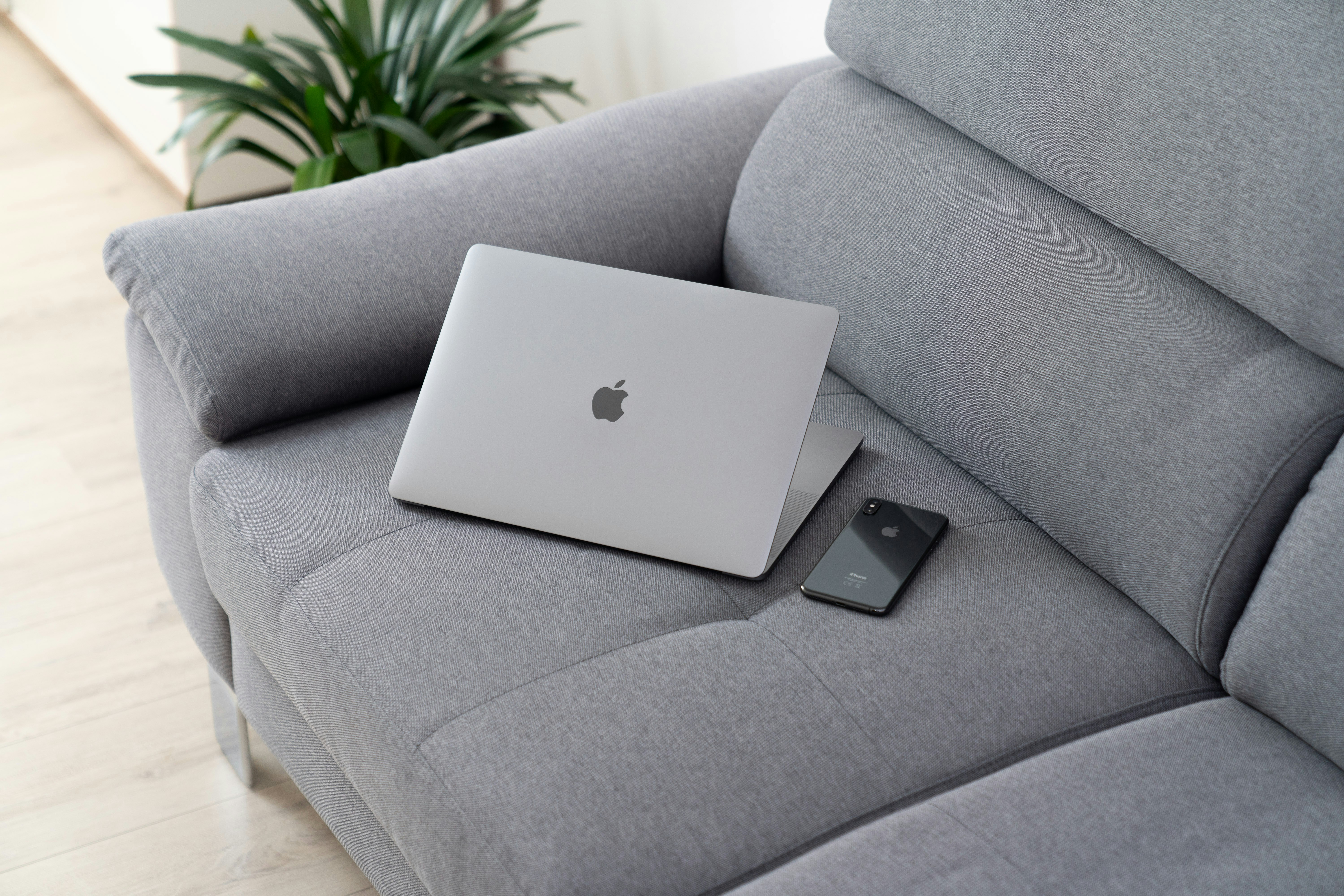 MacBook on grey sofa