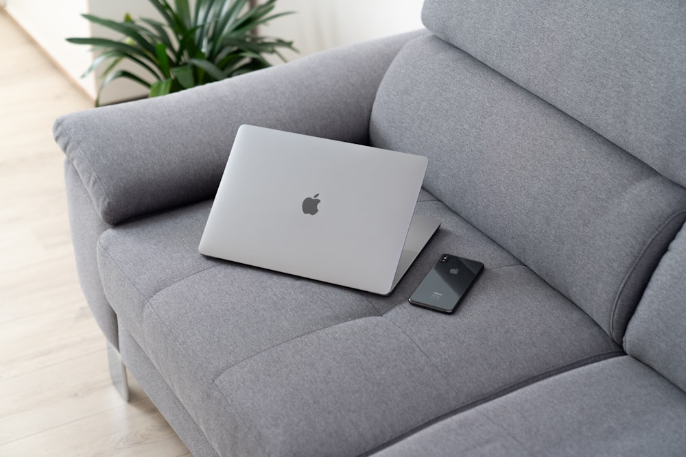 MacBook on grey sofa