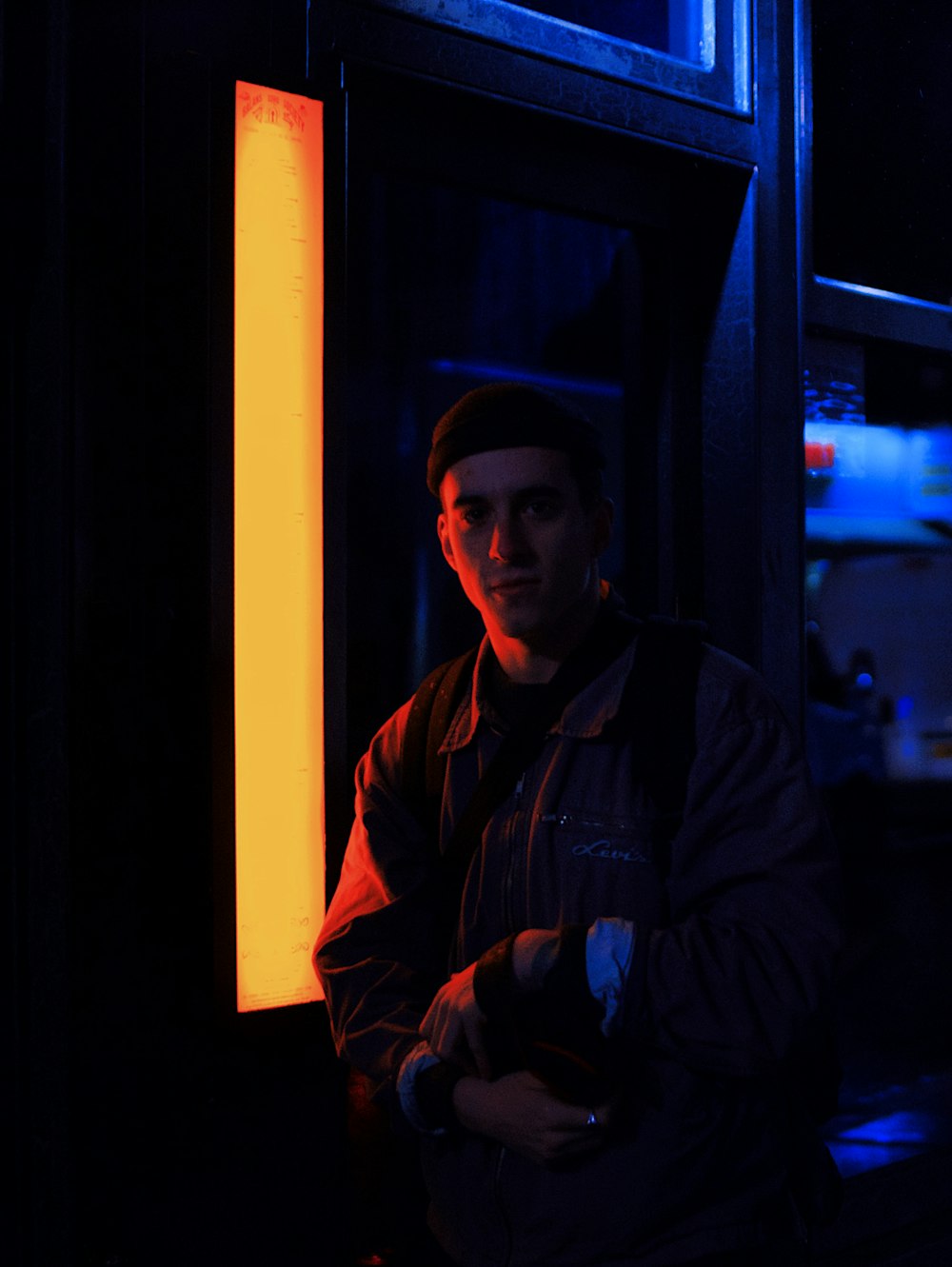 man standing beside street light