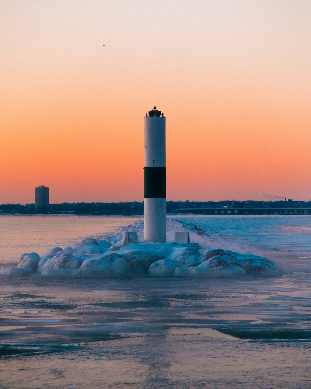 white and black lighthouse during daytime