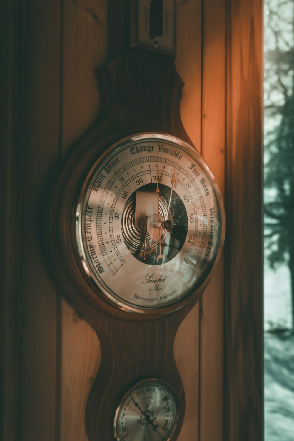 brown pendulum clock on wall