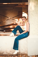 woman sitting on concrete building outdoor