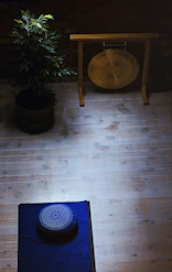 A peaceful corner of the studio decorated with spiritual symbols and cozy cushions for meditation.
