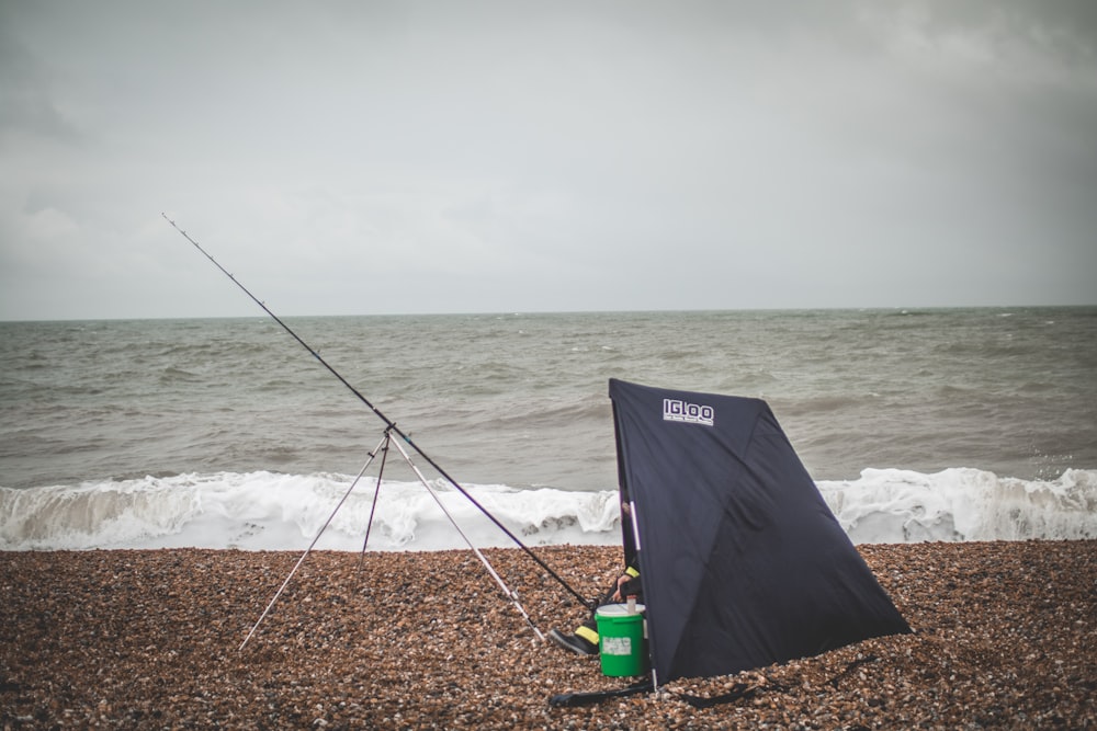 guarda-chuva preto na costa durante o dia