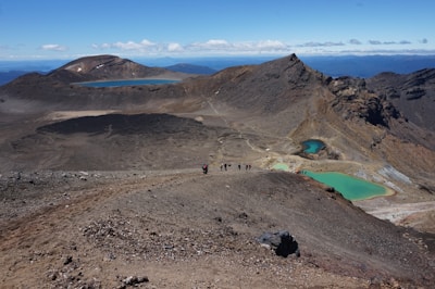 A scenic view of a volcano with hikers exploring the trails.