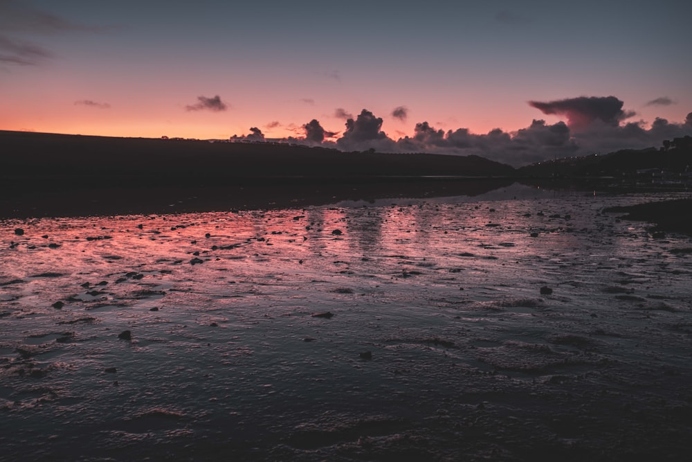 calm body of water during golden hour