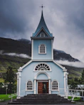 blue and white wooden church during daytime