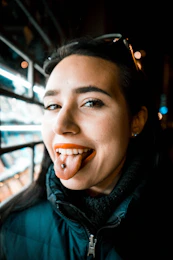 woman showing tongue with piercing