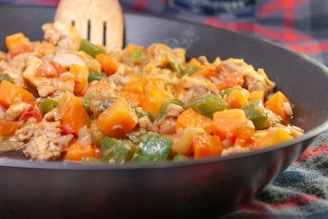 Close-up of a colorful Chinese stir-fry with crisp vegetables and tender chicken in a glossy sauce.