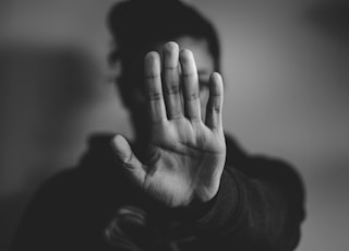 close-up photography of person lifting hands