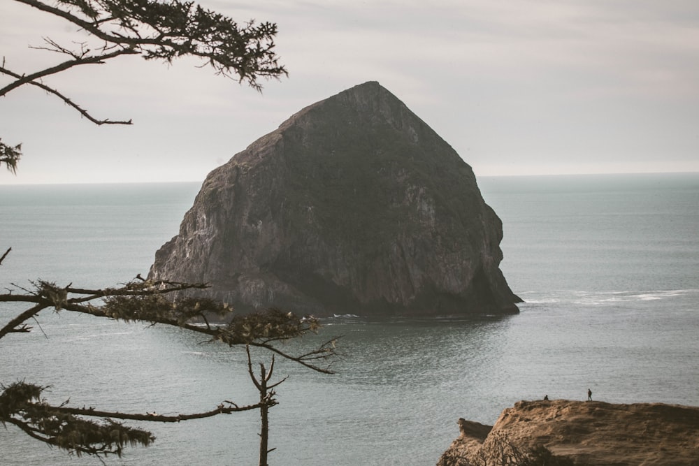 close-up photography of mountain surrounded by body of water