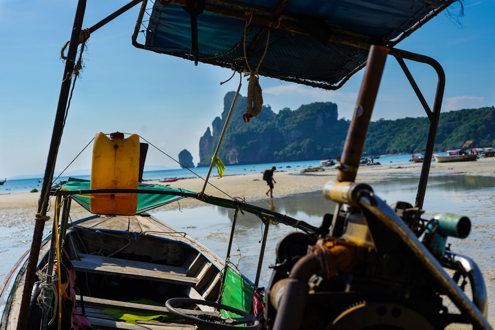 brown wooden boat on shore during daytime