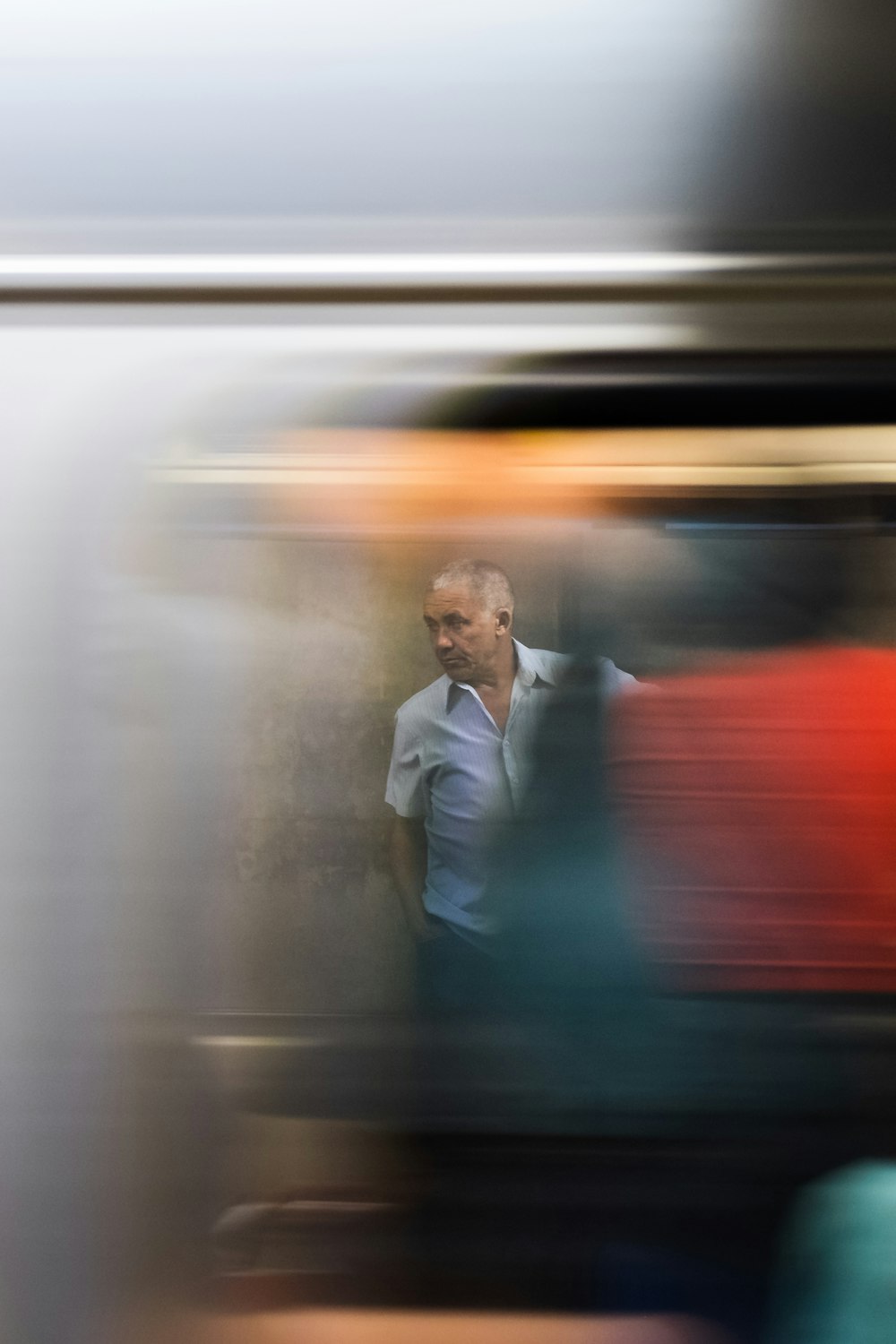 selective focus photography of standing man wearing gray button-up t-shirt