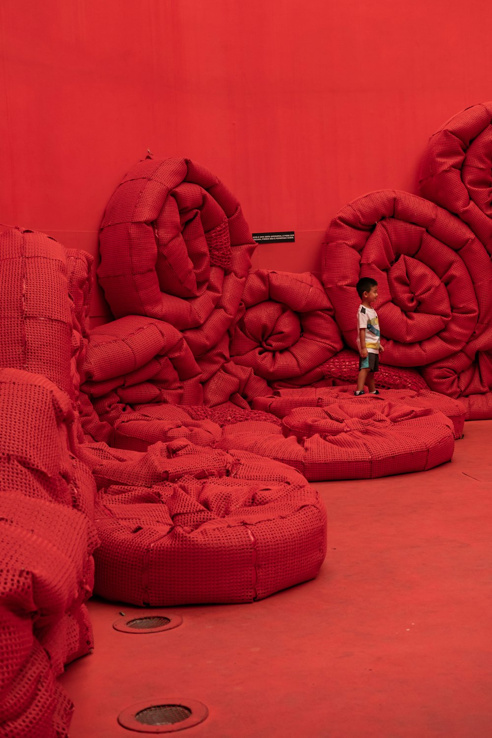 boy standing on round red pads