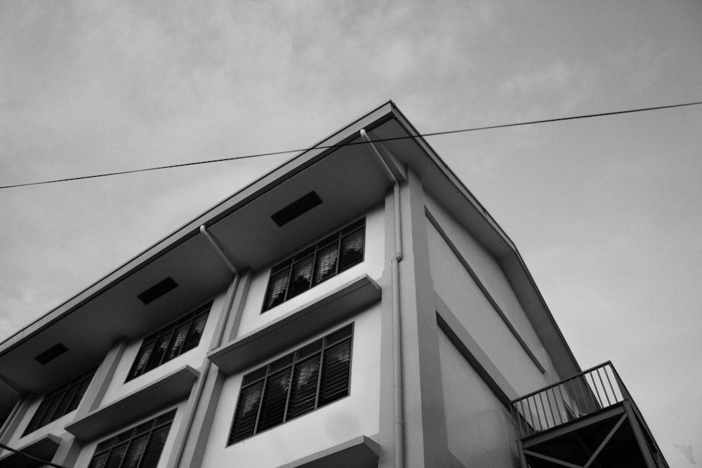 white concrete house under cloudy sky