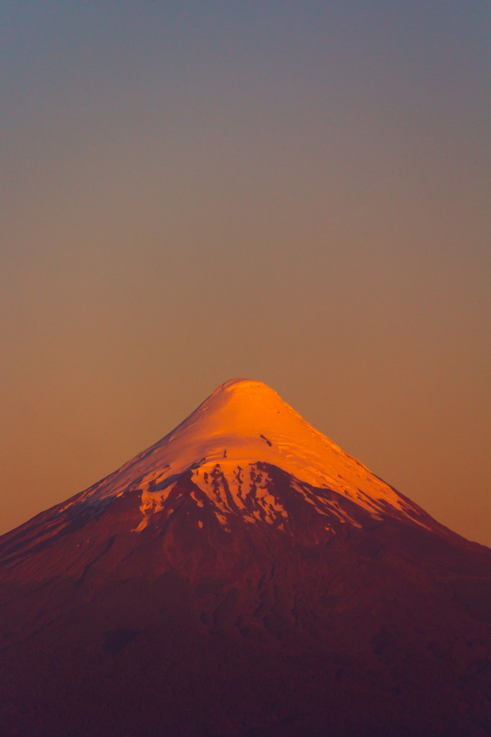 snow covered mountain during sunset